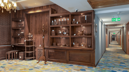 An image of a souvenir shop with a wooden cupboard with artefacts - Sarovar Premiere, Srinagar